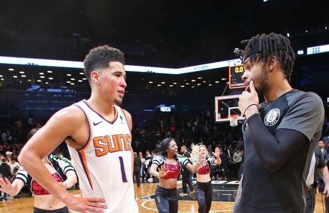 Devin Booker #1 of the Phoenix Suns talks with D'Angelo Russell