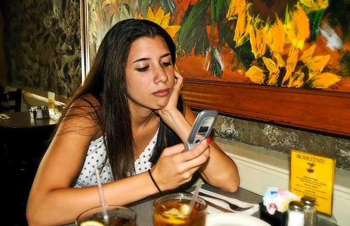 Teenager with a flip phone in 2006.