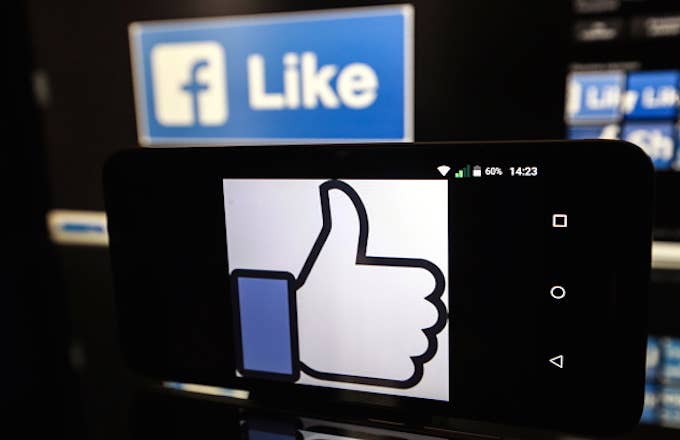 A Facebook thumbs up sign on a smartphone screen.