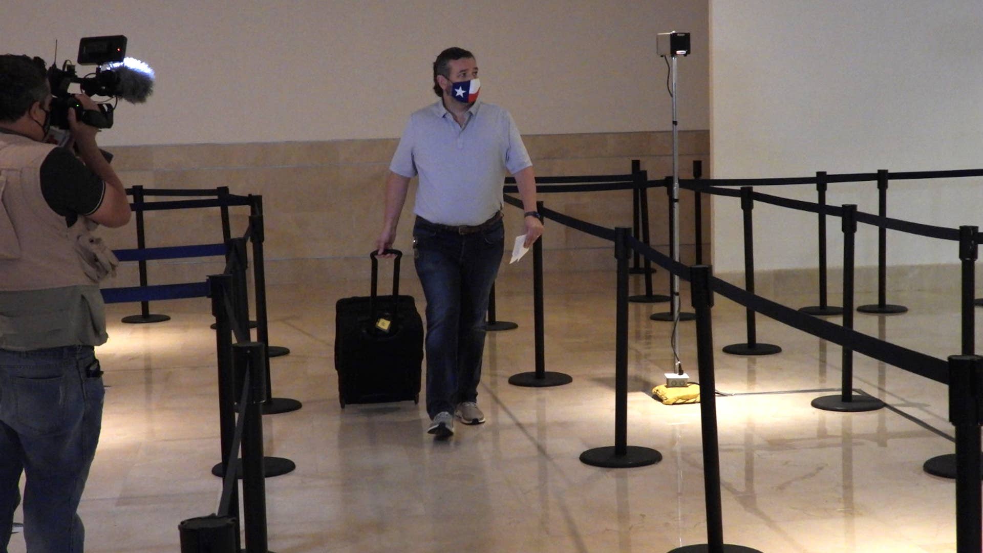 Sen. Ted Cruz (R TX) checks in for a flight at Cancun International Airport