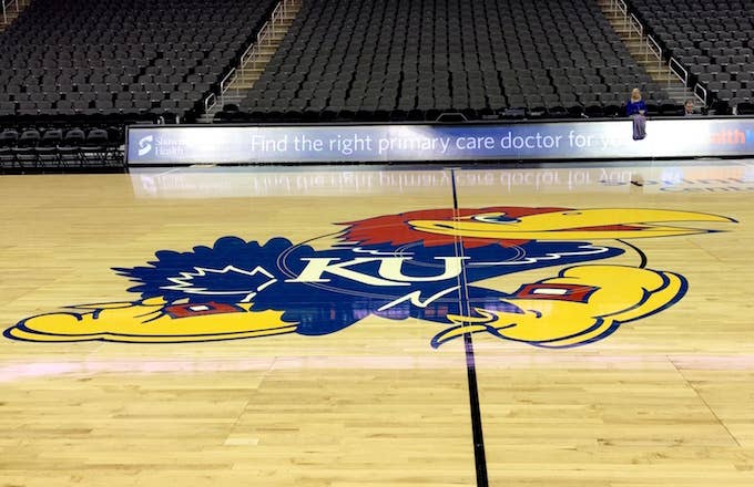 Kansas Jayhawks logo as it appears on a basketball court.