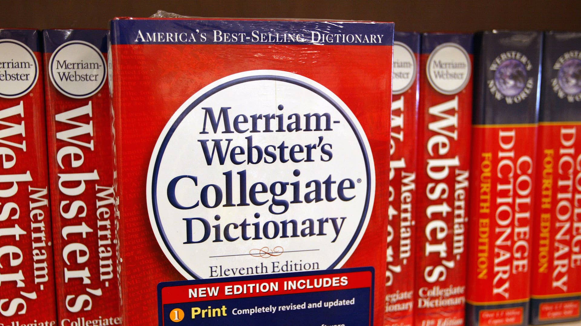 A Merriam Webster's Collegiate Dictionary is displayed in a bookstore.