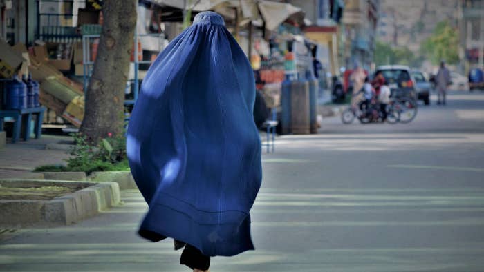 A woman walks through Afghanistan
