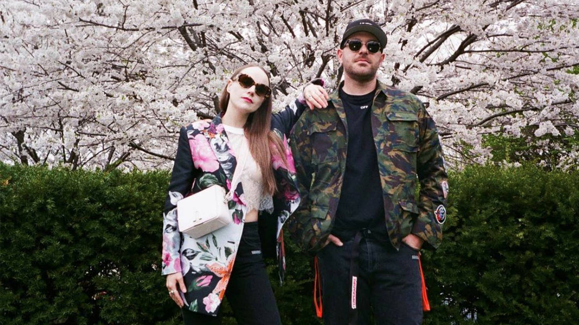 The founders of Sidewalk Hustle standing under a cherry blossom trees