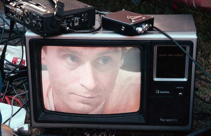 Ted Bundy&#x27;s image on a television screen on the lawn of the Florida State Prison.
