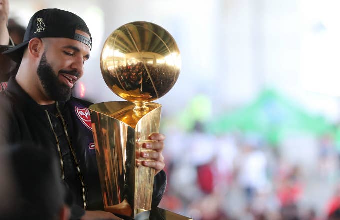 Drake holds the Larry O&#x27;Brien NBA Championship Trophy
