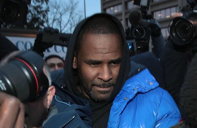 R. Kelly fights his way through photographers