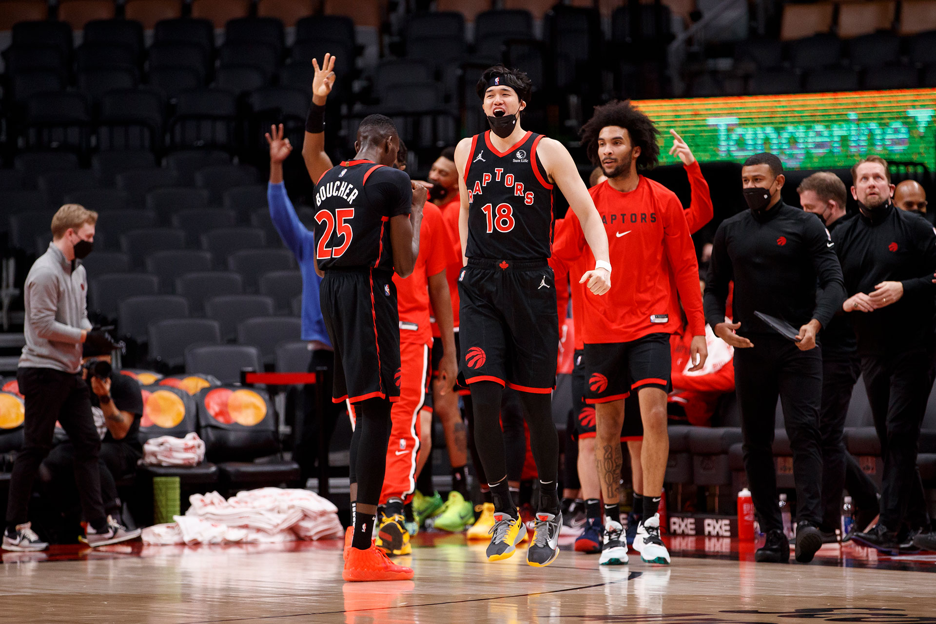 Yuta Watanabe #18 of the Toronto Raptors celebrates from the bench in the final seconds of their NBA game against the LA Clippers