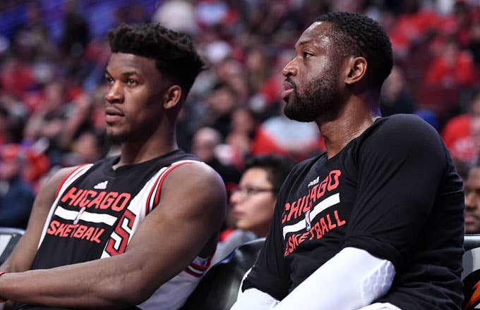 Jimmy Butler and Dwyane Wade sit on the Bulls bench.