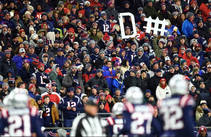 Fans hold a sign for the New England Patriots