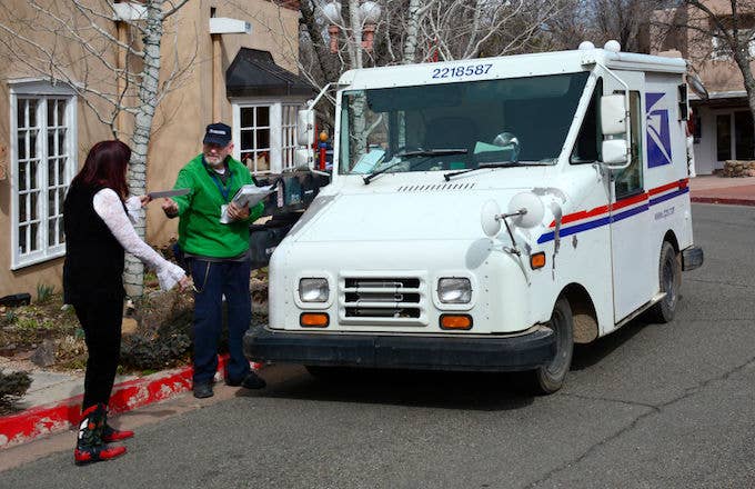 A USPS mailman delivering the mail.