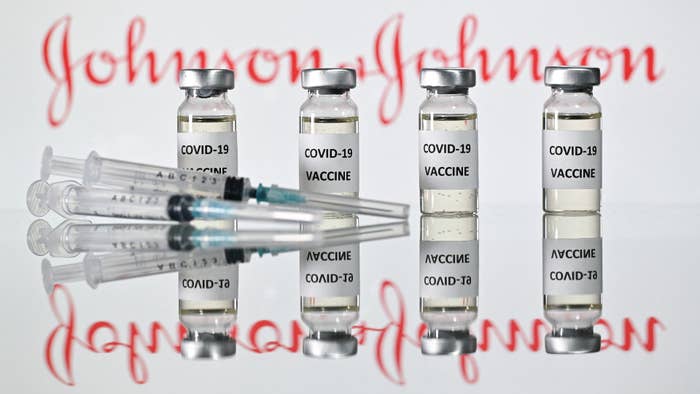 Illustration shows vials with Covid-19 Vaccine stickers with Johnson &amp; Johnson logo.