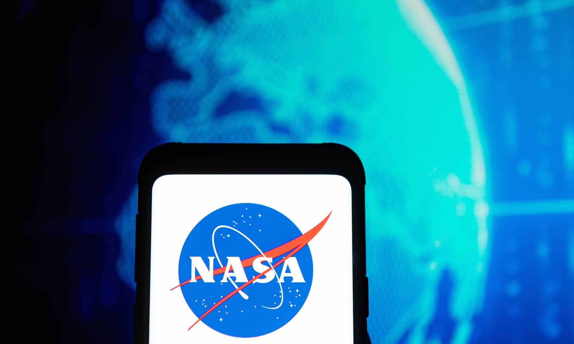 In this photo illustration a NASA logo seen displayed on a smartphone.