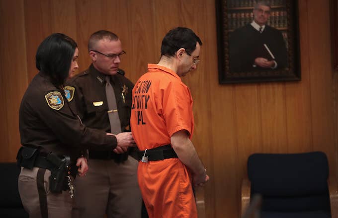 Larry Nassar is led from the courtroom
