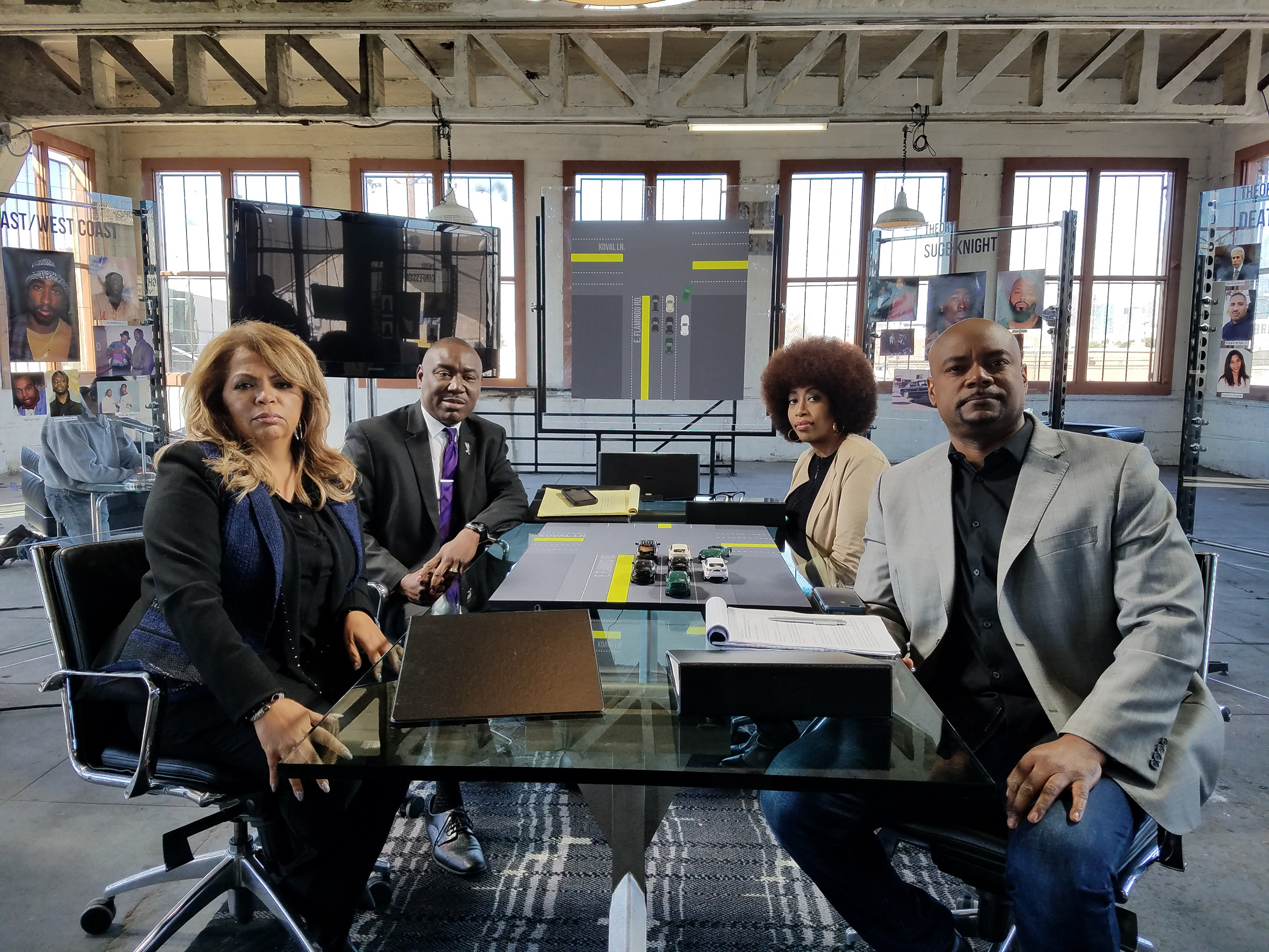 The cast of who killed tupac sit at a table.