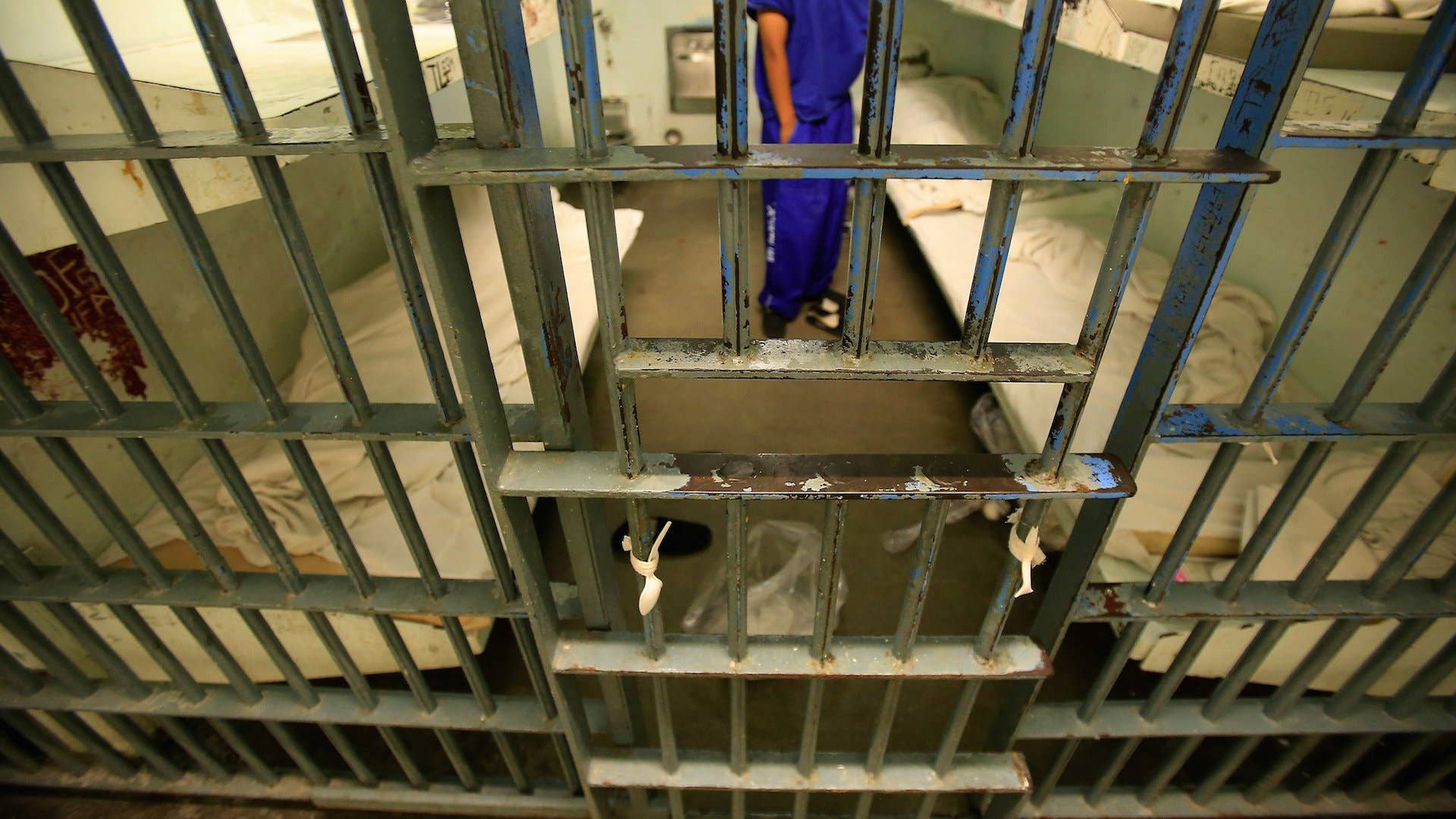 An inmate in a six bunk cell inside the Men's Central Jail