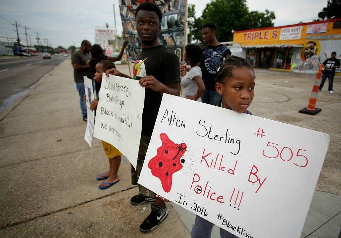 Demonstrators protest the fatal police shooting of Alton Sterling