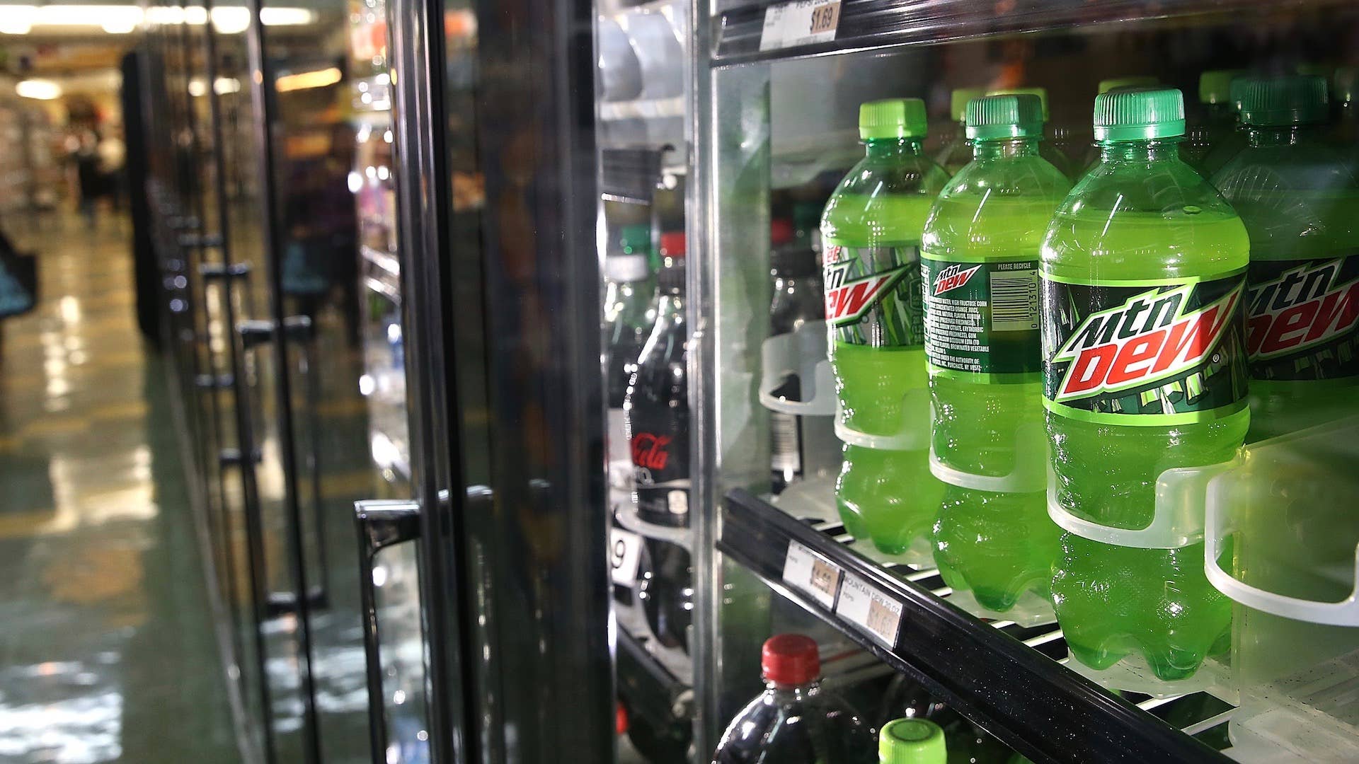 Bottles of Mountain Dew are displayed in a cooler