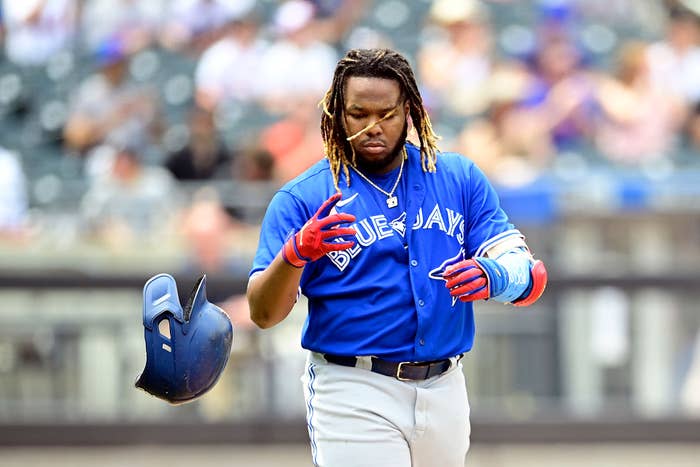 Vladimir Guerrero Jr. #27 of the Toronto Blue Jays tosses his helmet after flying out against the New York Mets