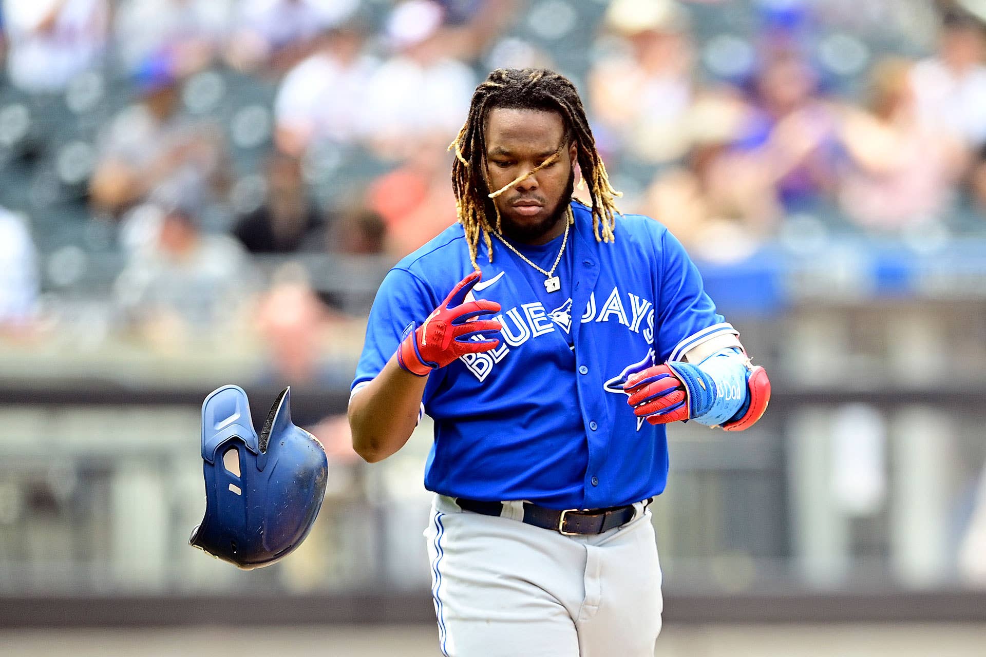 Vladimir Guerrero Jr. #27 of the Toronto Blue Jays tosses his helmet after flying out against the New York Mets