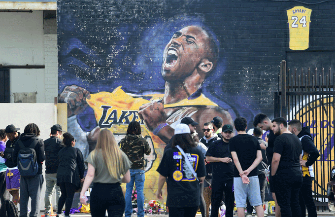 Fans surround a Kobe Bryant mural in the hours after his death.