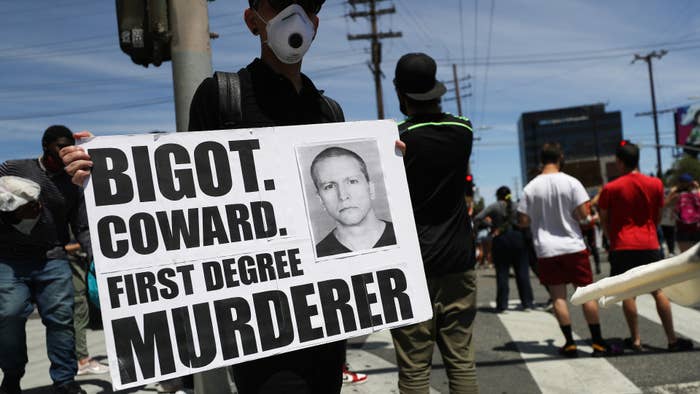 Protester holds up sign with Derek Chauvin