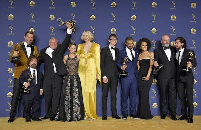 George RR Martin and the cast of Game of Thrones pose with the Emmy for Outstanding Drama Series.
