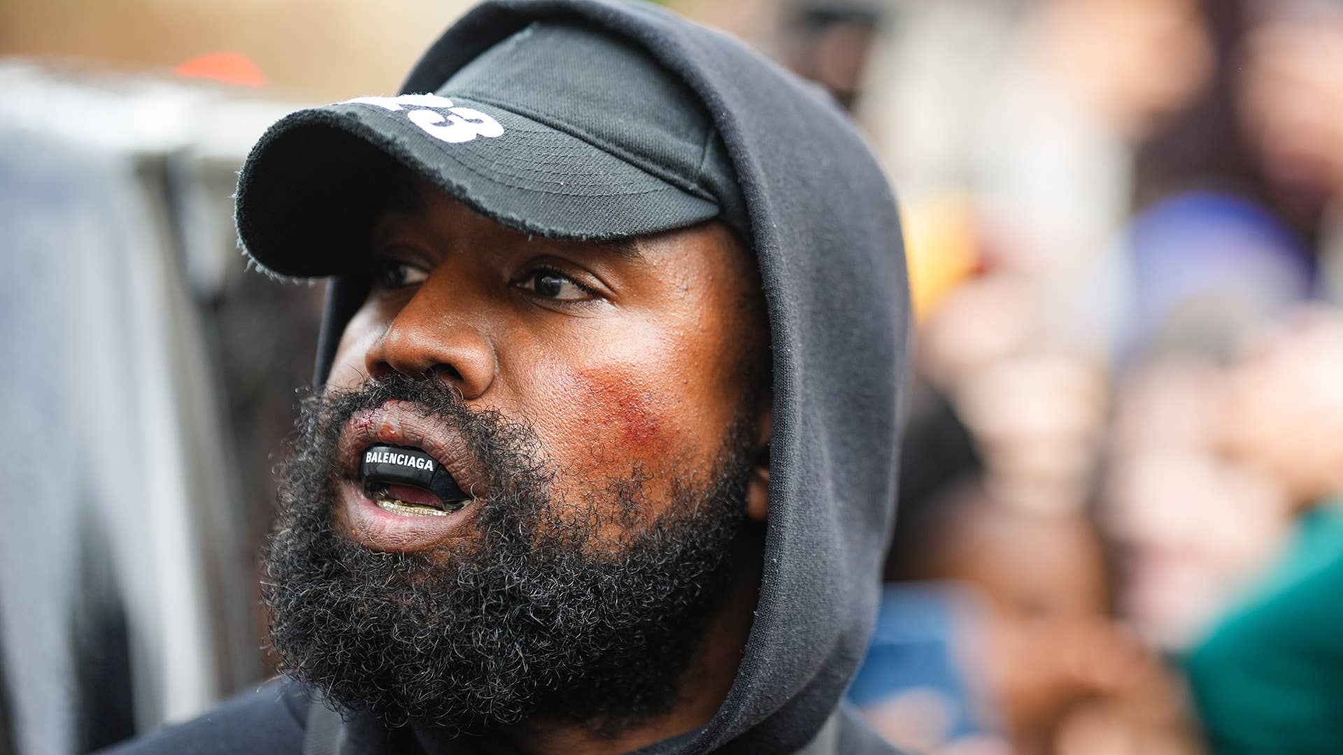 Kanye West aka Ye is seen wearing a Balenciaga boxing mouthguard, outside Givenchy, during Paris Fashion Week