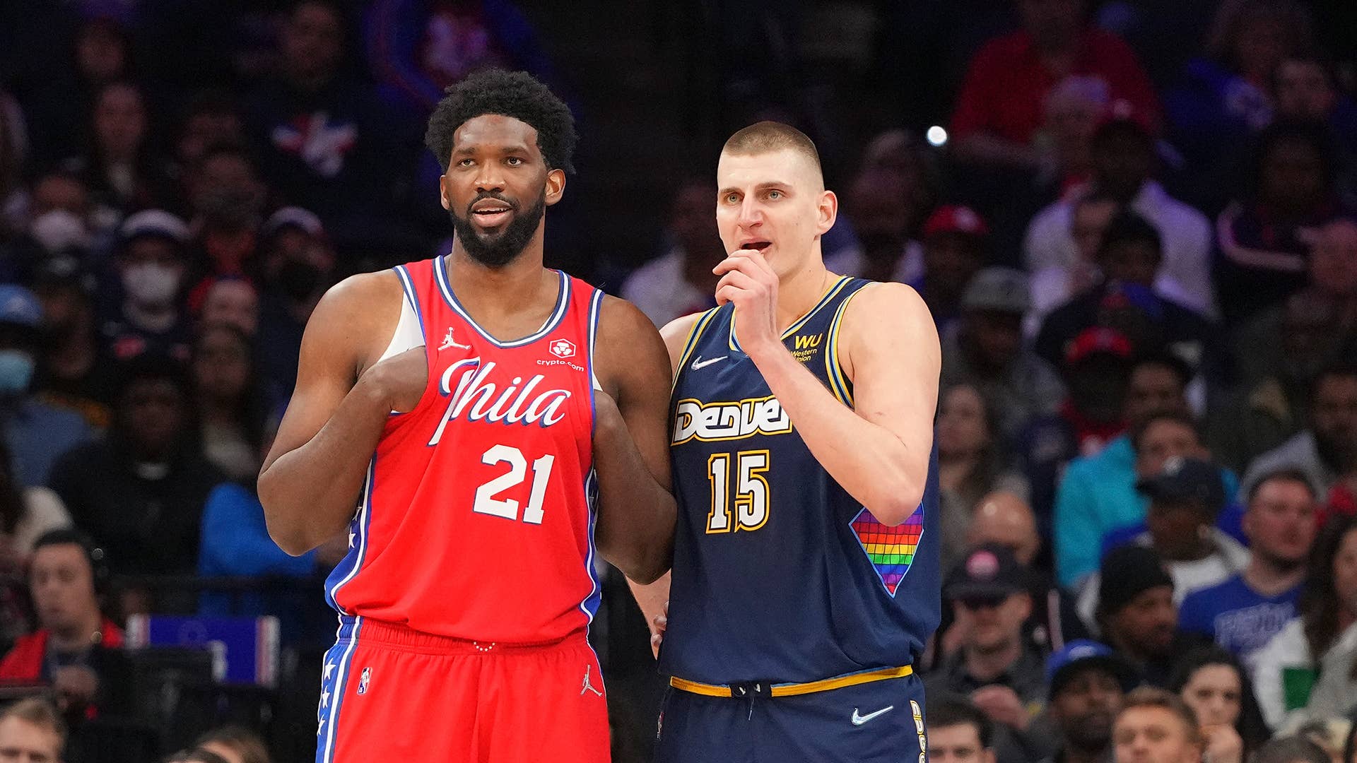 Joel Embiid #21 of the Philadelphia 76ers talks to Nikola Jokic #15 of the Denver Nuggets