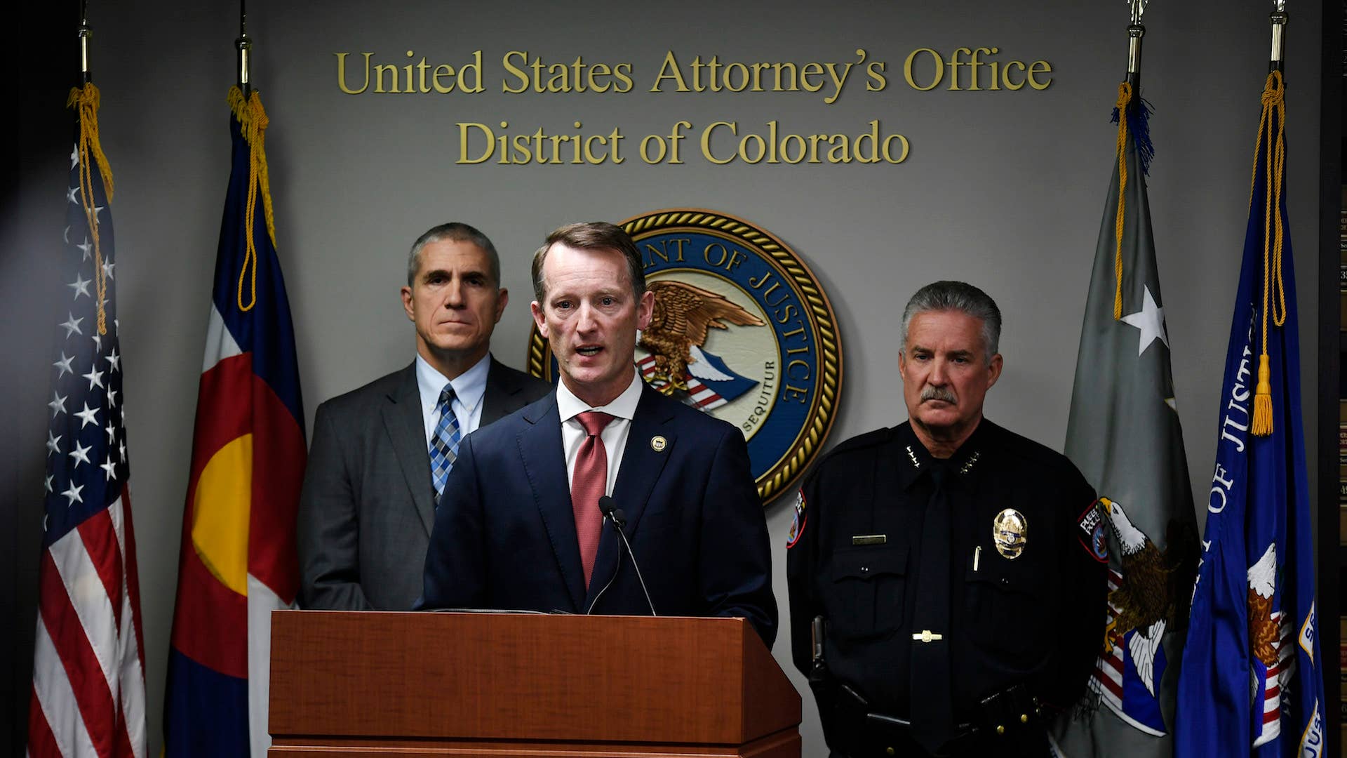 U.S. Attorney Jason R. Dunn, center, speaks during a press conference