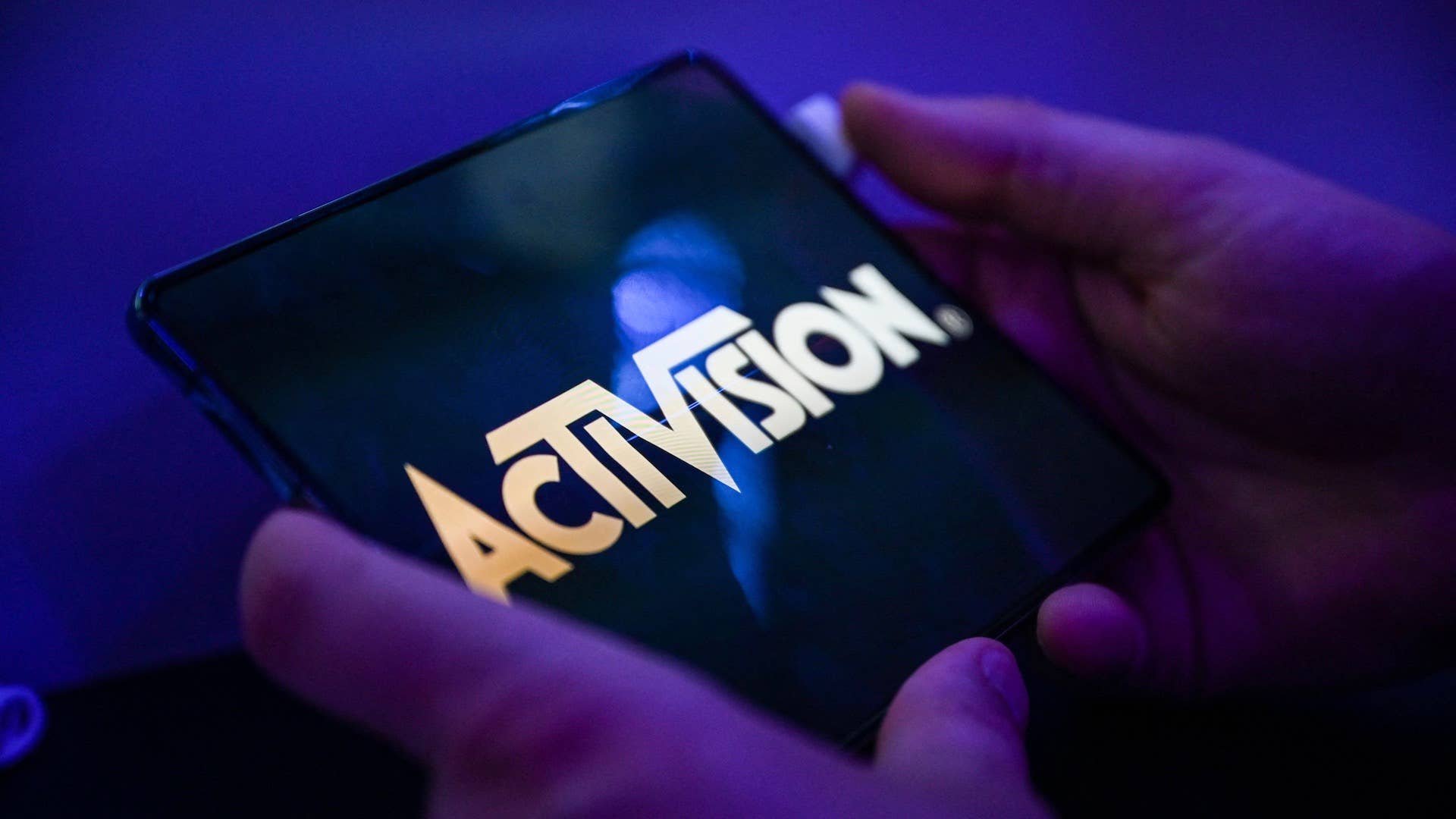 A visitor plays the game 'Call of Duty' of Activision on a mobile phone