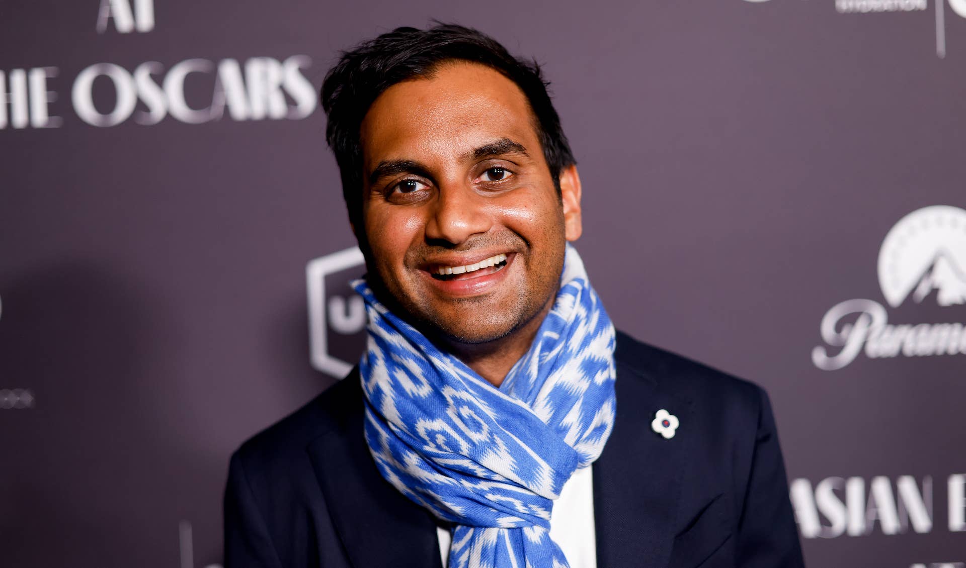 Aziz Ansari smiling in 2023