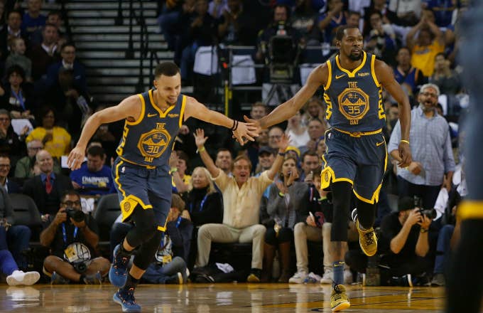 Stephen Curry #30 and Kevin Durant #35 of the Golden State Warriors celebrate a basket