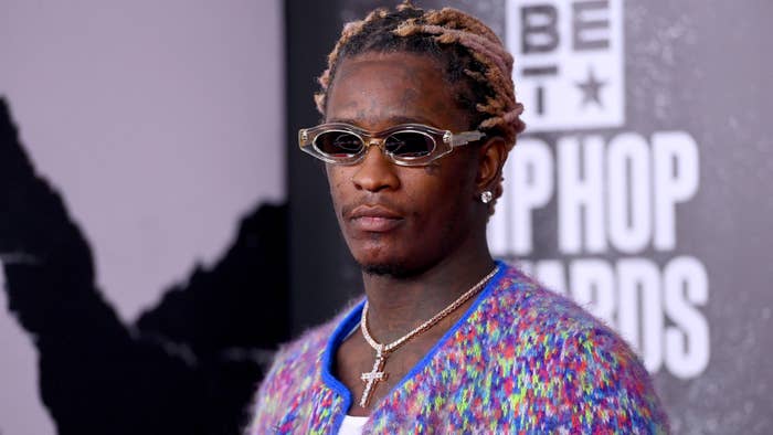 Young Thug walks the red carpet in a cross necklace.