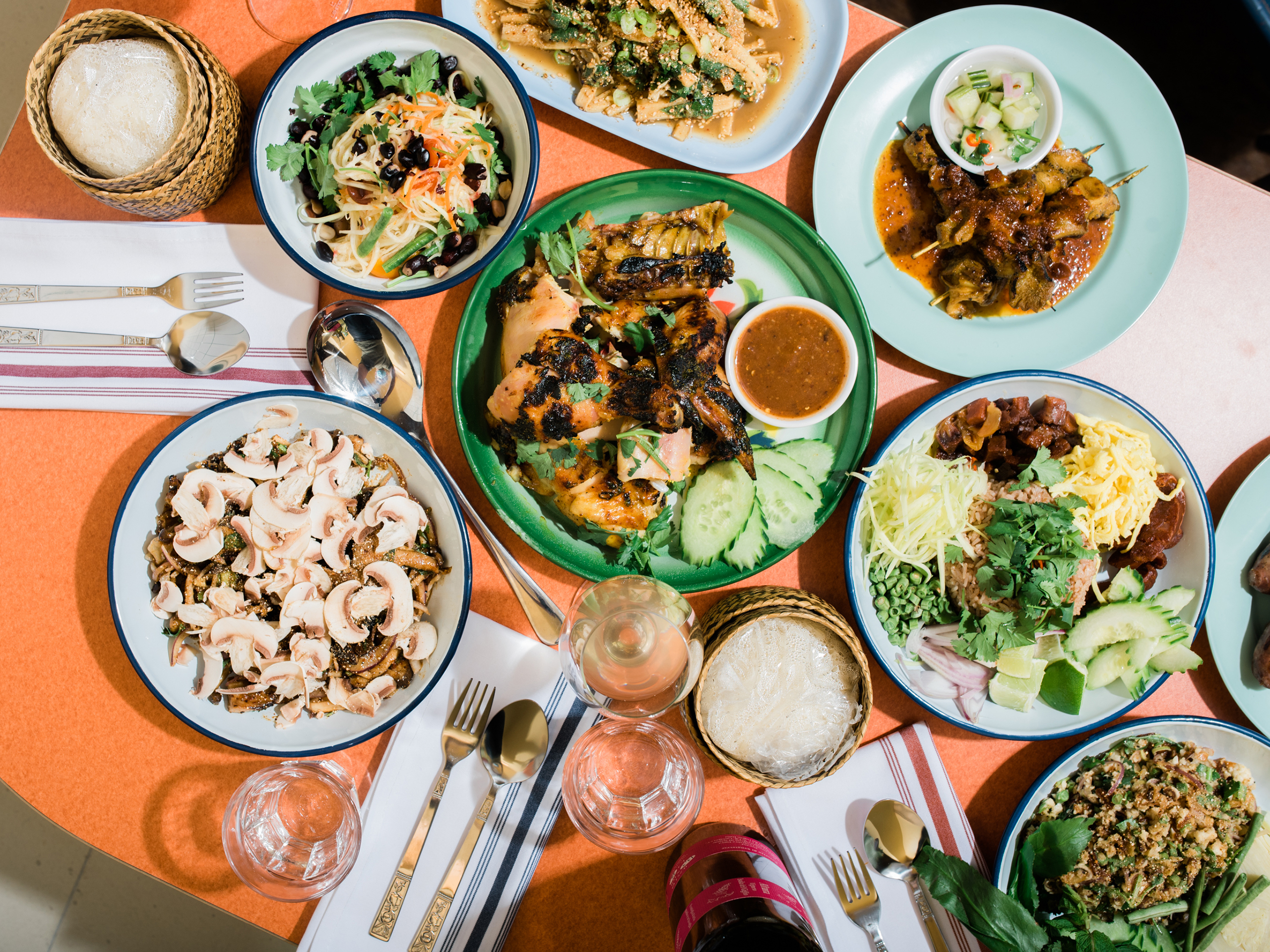 pichai&#x27;s delicious Thai offerings spread across plates on an orange table