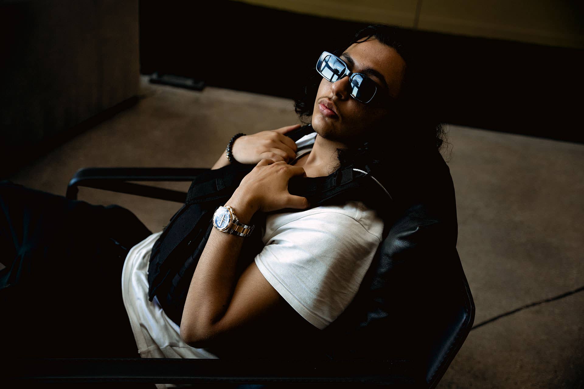 Toronto artist RealestK poses in dark sunglasses and vest