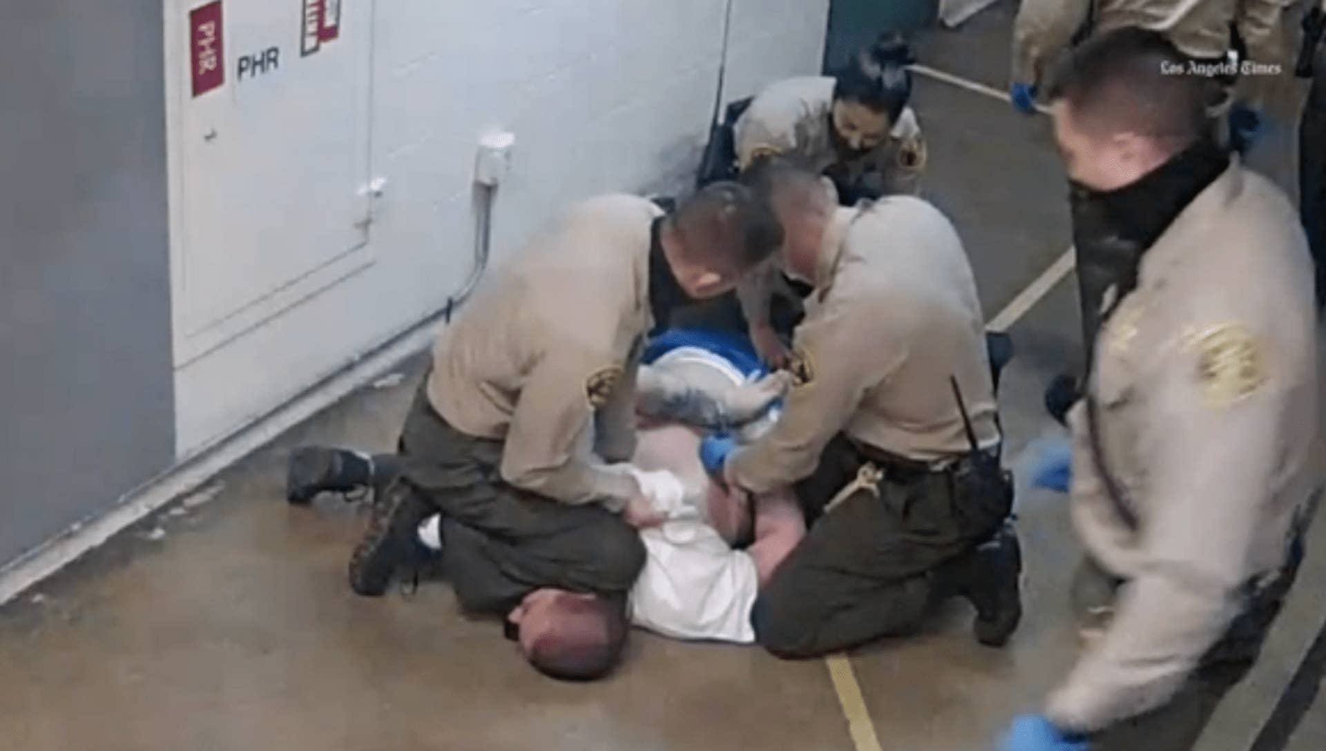 Image of LASD deputy kneeling on man's head