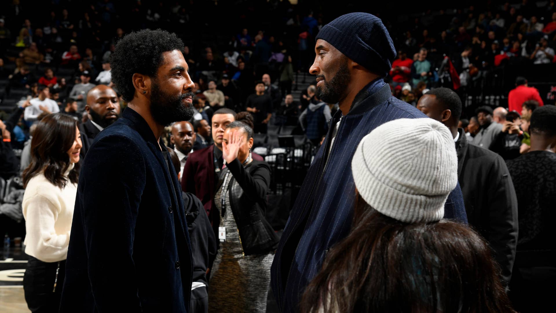 Kobe Bryant talks with Kyrie Irving during the game against the Atlanta Hawks.