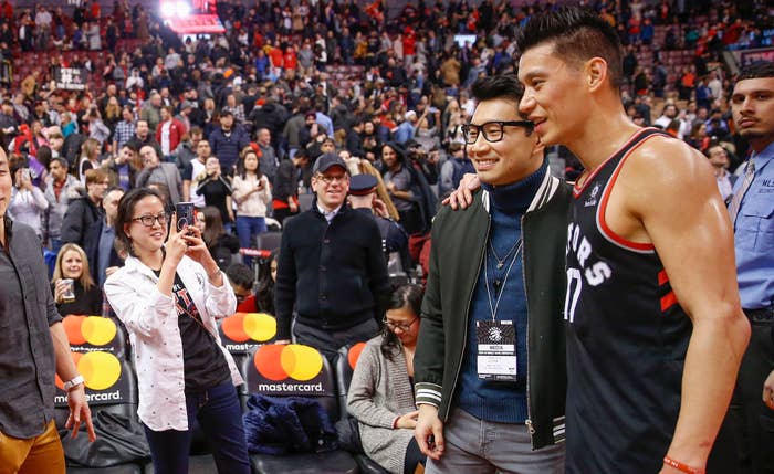 Raptors team photographer Ron Turenee snaps a photo of Simu Liu and Jeremy Lin