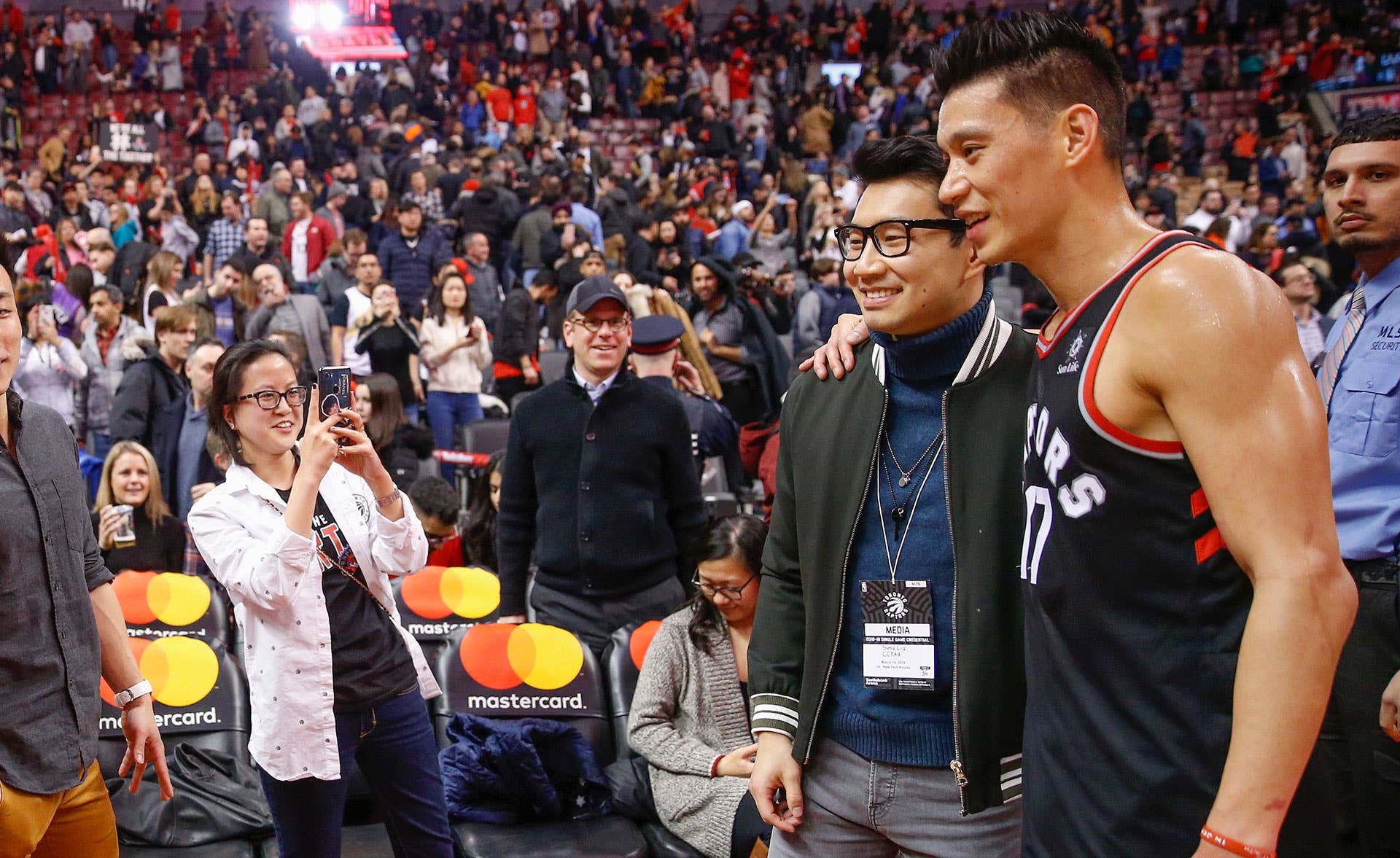 Raptors team photographer Ron Turenee snaps a photo of Simu Liu and Jeremy Lin