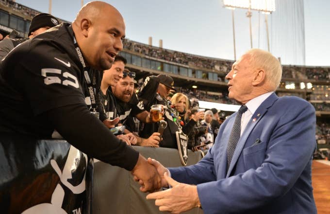Jerry Jones shakes hands with Raiders fans.