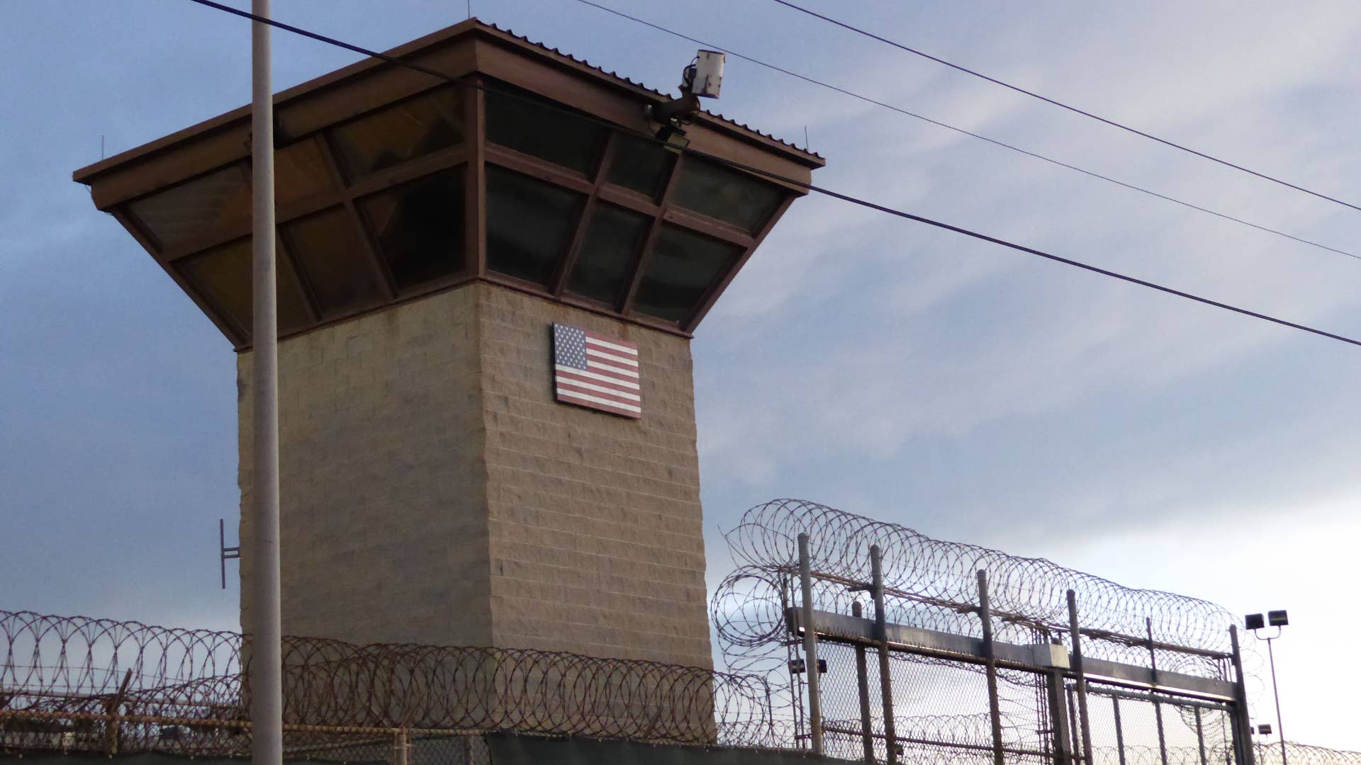 An American flag is shown above a prison entrance.