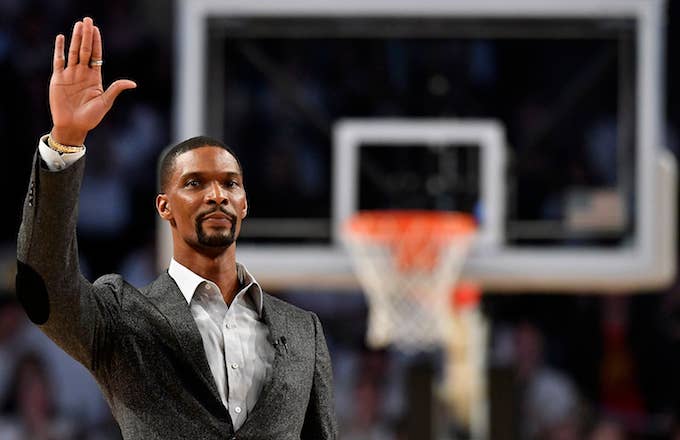 Chris Bosh waves to the crowd during a stoppage in play.