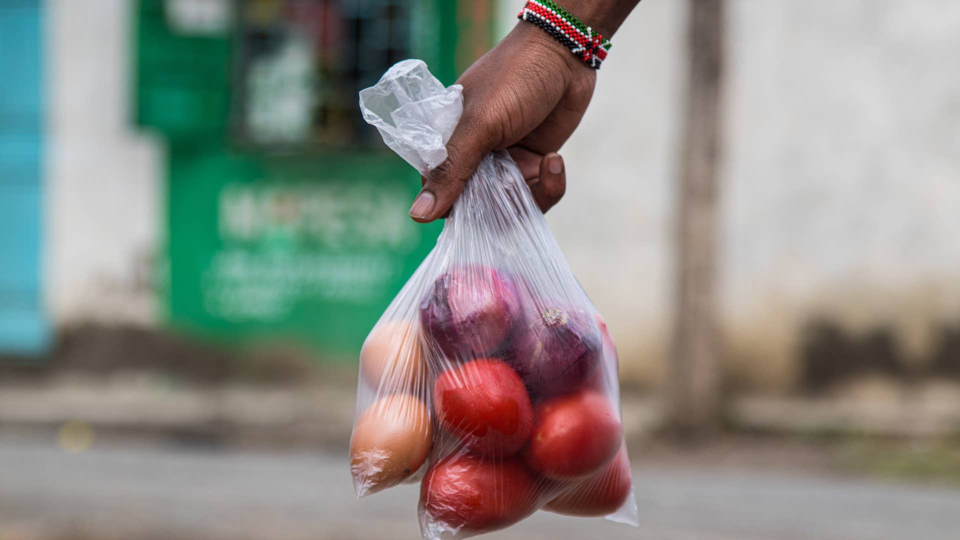 Photograph of man holding produce bag