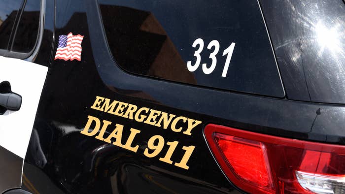 A police car with &#x27;Emergency Dial 911&#x27; on its side parked in Santa Fe, New Mexico.