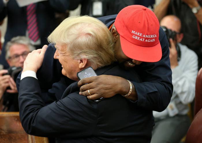 Donald Trump hugs rapper Kanye West during a meeting in the Oval office of the White House