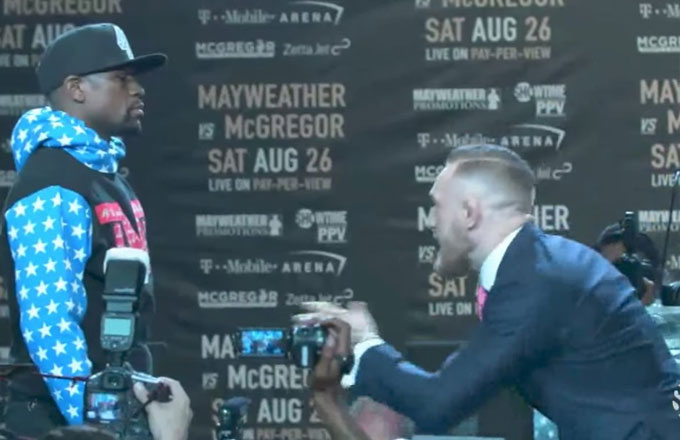 Conor McGregor taunts Floyd Mayweather during their introductory press conference.