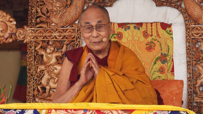 Tibetan spiritual leader Dalai Lama gestures as he leads a teachings gathering in Leh