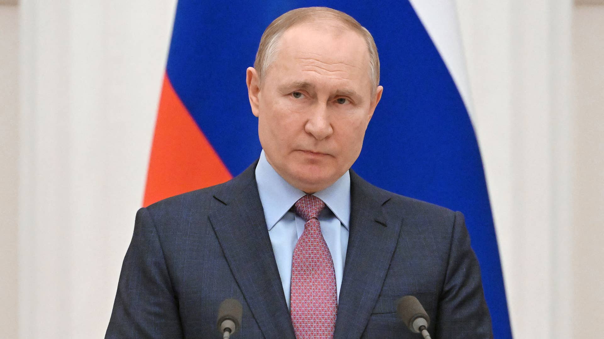 Vladimir Putin is pictured at a podium
