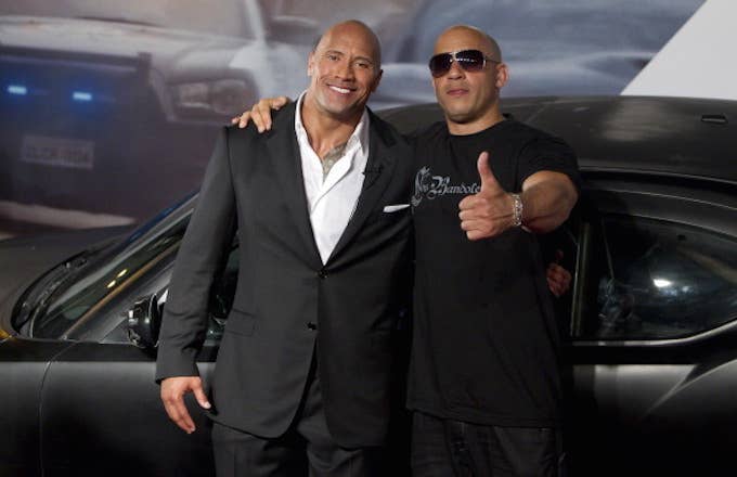 Dwayne Johnson (The Rock) and Vin Diesel (R) pose for photographers